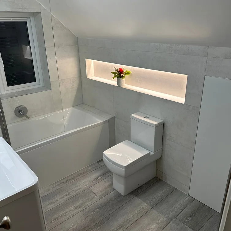 Modern bathroom featuring illuminated wall niche and contemporary fixtures