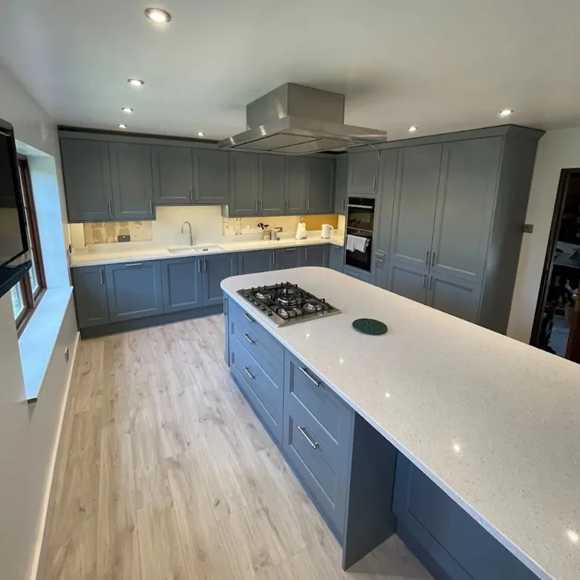 Large modern kitchen with blue-grey cabinets and white island