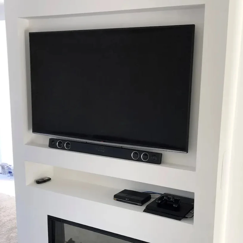 Custom built-in TV wall unit with integrated sound system and storage